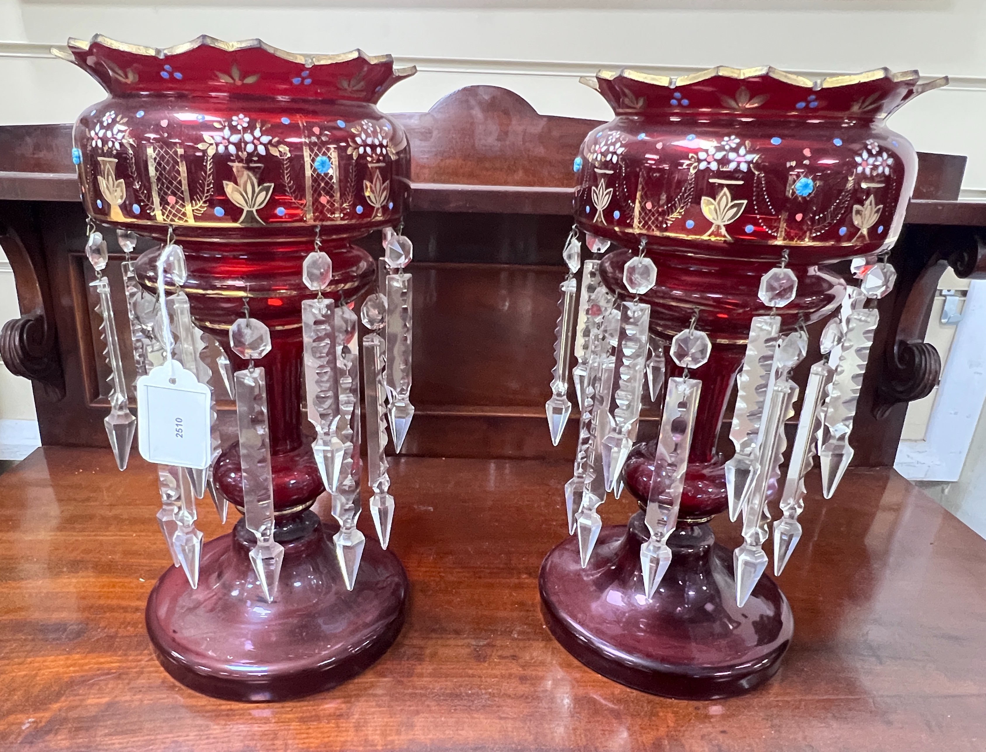 A pair of Victorian ruby glass table lustres, 36 cms high